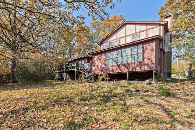 rear view of property with a wooden deck