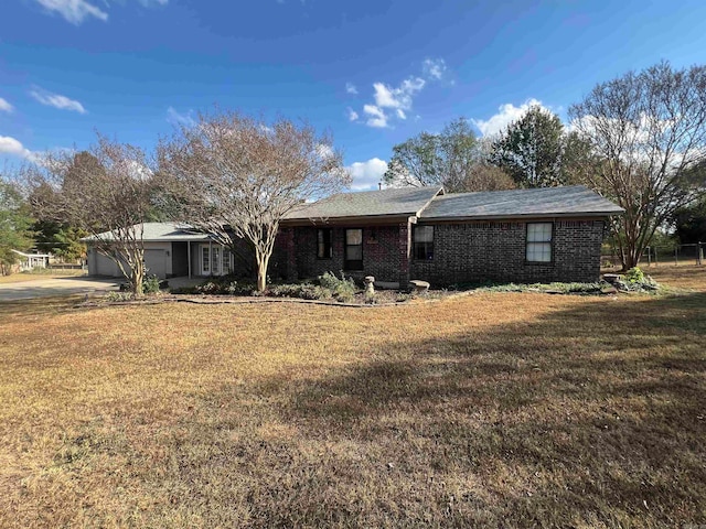 view of front of house with a front yard and a garage