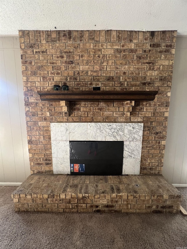 8096 Zuber Rd, Benton, AR 72019 - detailed view of carpet flooring, a fireplace, a textured ceiling, and wood walls