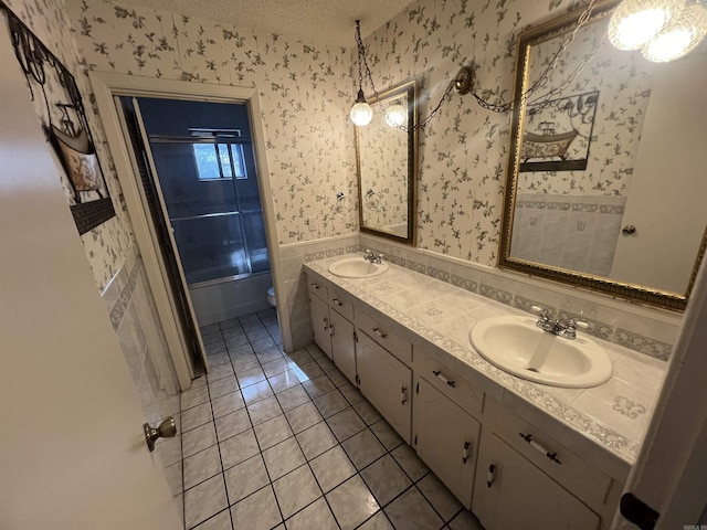 8096 Zuber Rd, Benton, AR 72019 - bathroom with double vanity, wallpapered walls, tile patterned flooring, toilet, and a textured ceiling