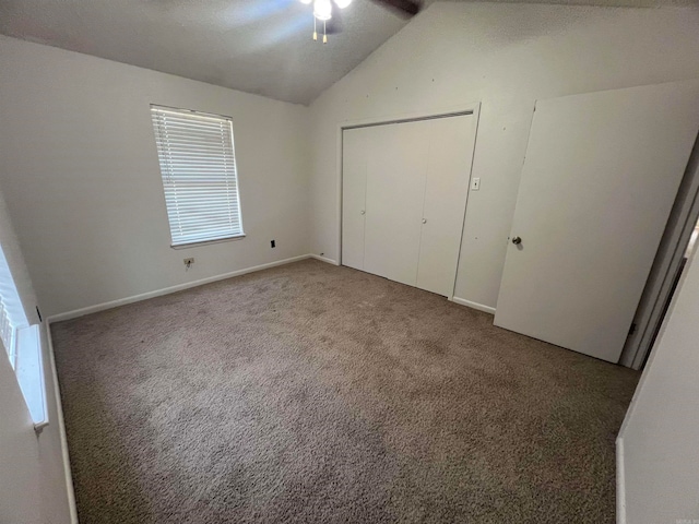 unfurnished bedroom with lofted ceiling, carpet floors, and ceiling fan