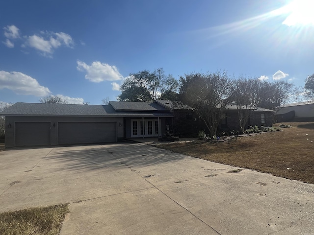8096 Zuber Rd, Benton, AR 72019 - view of front of home featuring french doors, a garage, and concrete driveway