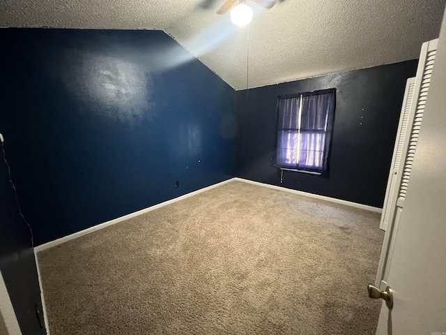 8096 Zuber Rd, Benton, AR 72019 - empty room featuring a textured ceiling, lofted ceiling, carpet floors, a ceiling fan, and baseboards