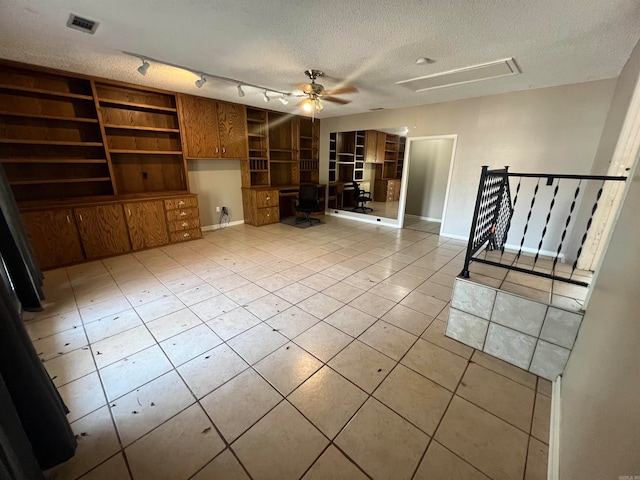 unfurnished living room featuring ceiling fan, a textured ceiling, and light tile patterned floors