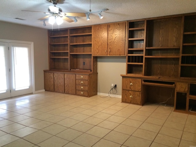 unfurnished office with ceiling fan, a textured ceiling, and light tile patterned floors