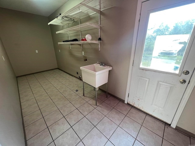 washroom featuring sink, hookup for a washing machine, and light tile patterned floors