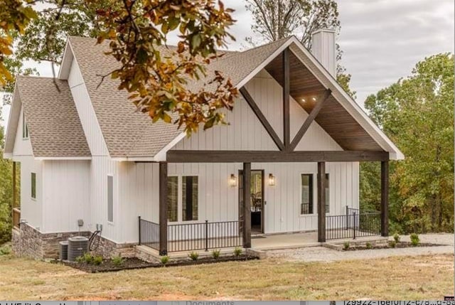 view of front facade with central AC and a porch