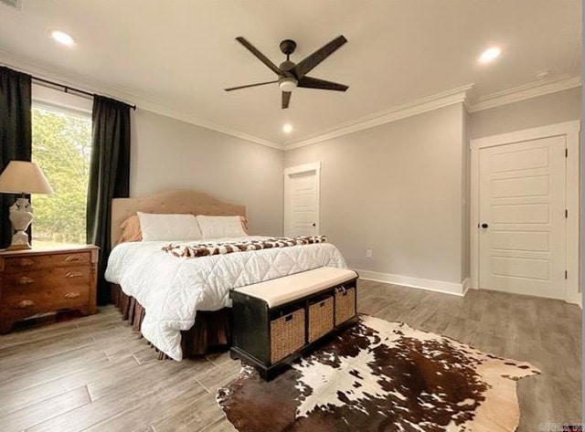 bedroom with ceiling fan, crown molding, and wood-type flooring