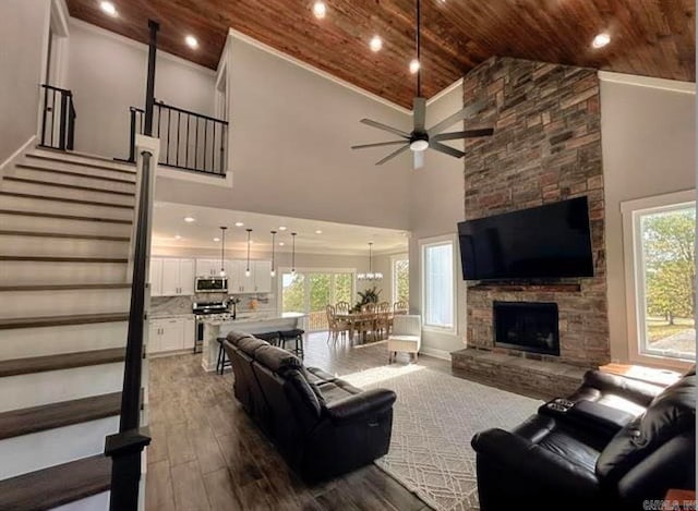 living room with high vaulted ceiling, wooden ceiling, wood-type flooring, and plenty of natural light