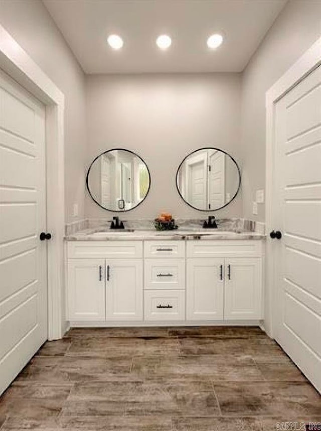 bathroom with vanity and hardwood / wood-style floors