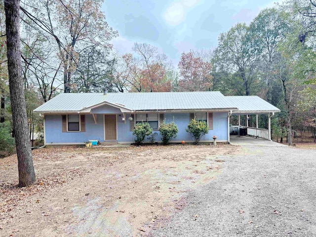 single story home featuring a carport