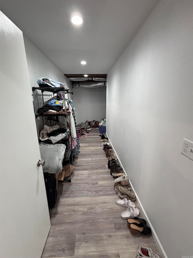 walk in closet with light hardwood / wood-style flooring