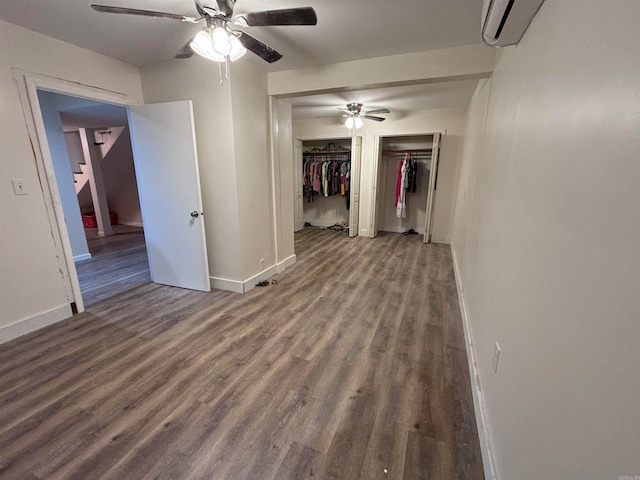 hall featuring dark wood-type flooring and a wall unit AC