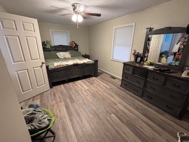 bedroom with hardwood / wood-style floors and ceiling fan