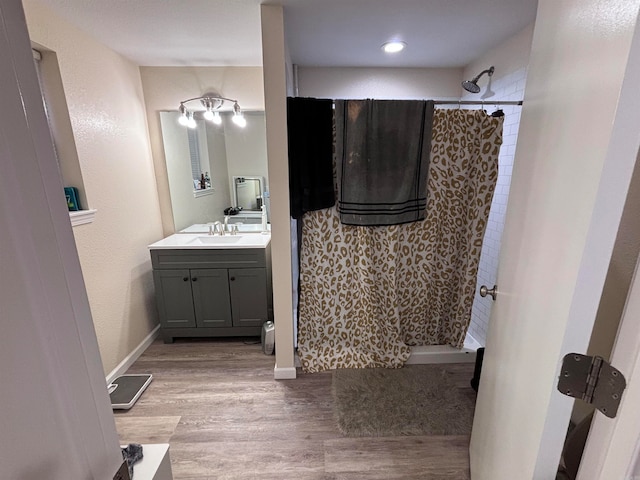 bathroom with vanity, hardwood / wood-style flooring, and a shower with curtain