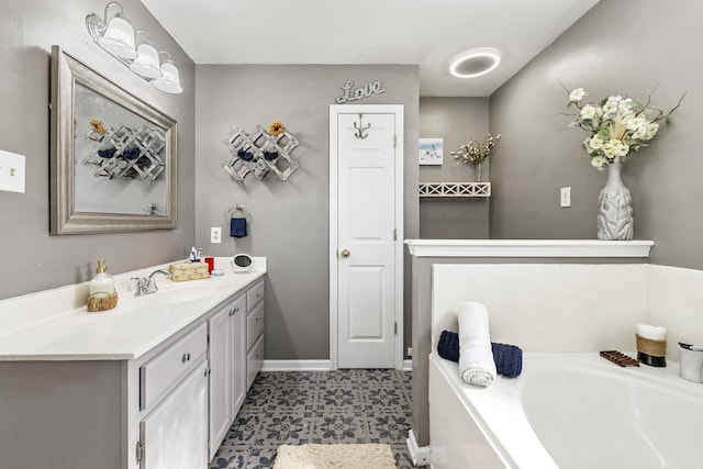 bathroom with vanity and a tub