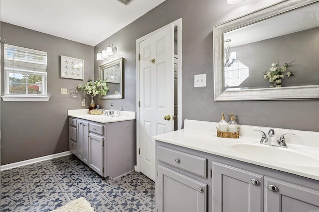 bathroom featuring vanity, tile patterned floors, and an inviting chandelier