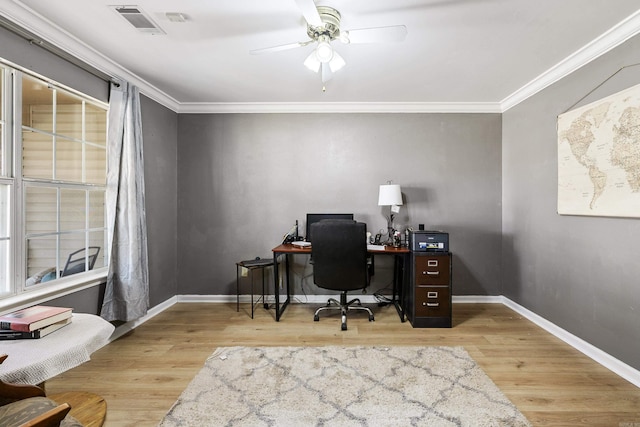 home office featuring crown molding, light wood-type flooring, and ceiling fan