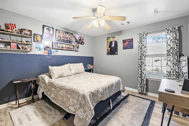 bedroom with light hardwood / wood-style flooring and ceiling fan