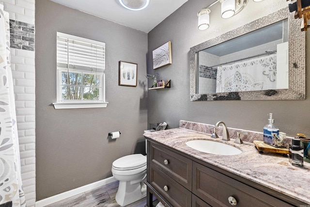 bathroom with vanity, toilet, walk in shower, and hardwood / wood-style floors