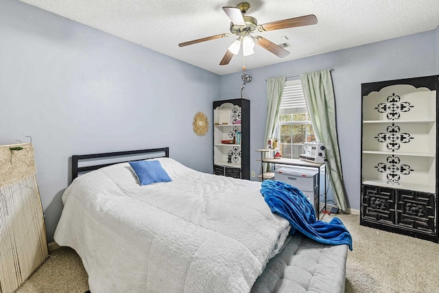 bedroom featuring a textured ceiling, carpet flooring, and ceiling fan