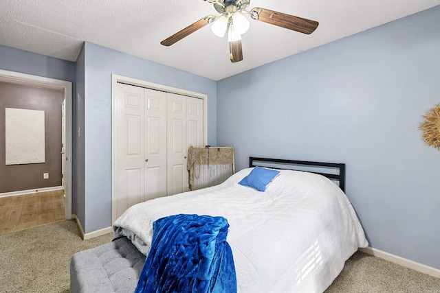 carpeted bedroom featuring a textured ceiling, a closet, and ceiling fan