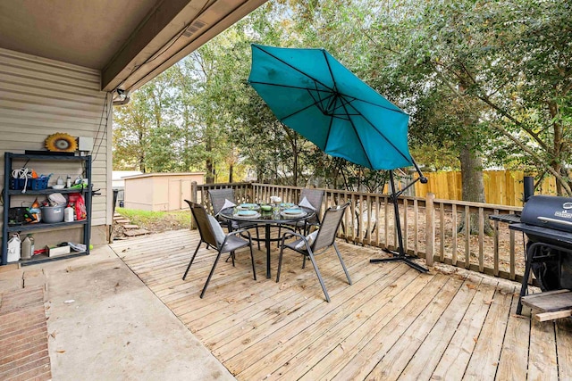 deck featuring a storage unit and area for grilling