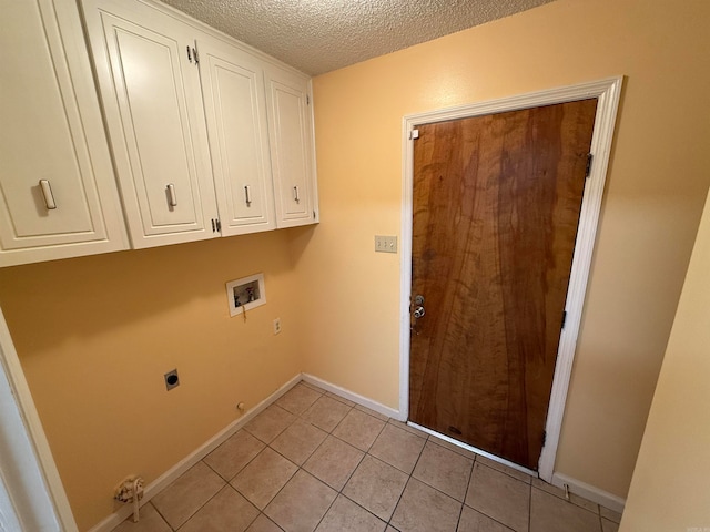 laundry area featuring a textured ceiling, cabinets, electric dryer hookup, washer hookup, and light tile patterned floors