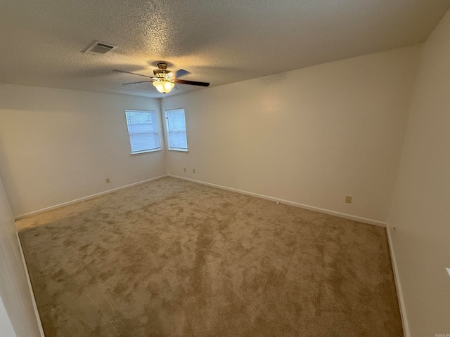 carpeted empty room with a textured ceiling and ceiling fan