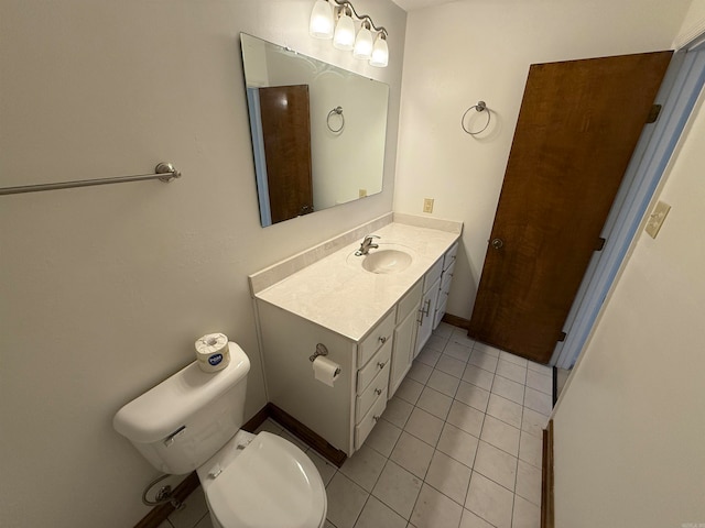 bathroom with vanity, toilet, and tile patterned floors