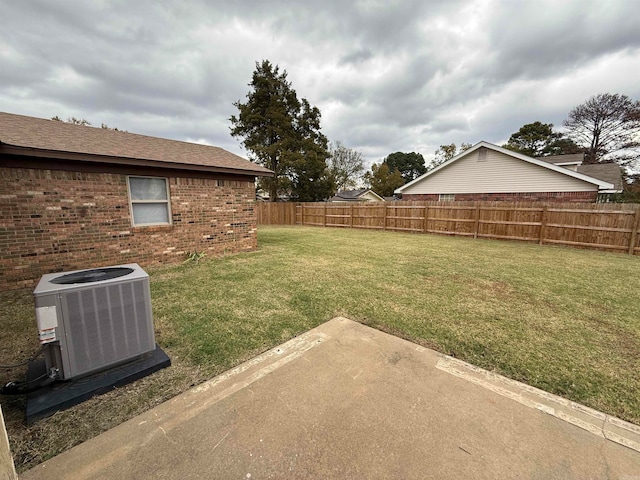 view of yard with cooling unit and a patio