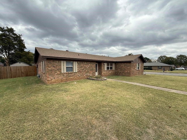 ranch-style home featuring a front yard