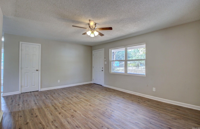 spare room with ceiling fan, a textured ceiling, and light hardwood / wood-style flooring