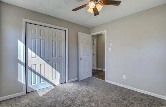 unfurnished bedroom with a closet, carpet floors, a textured ceiling, and ceiling fan