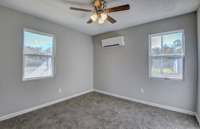 unfurnished room with ceiling fan, a healthy amount of sunlight, carpet, and a wall mounted air conditioner