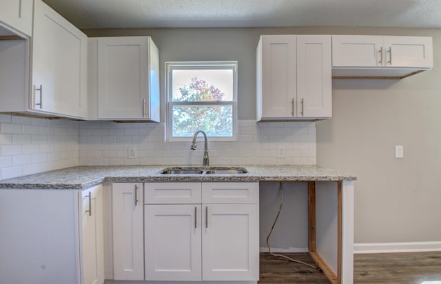 kitchen with white cabinetry, sink, and dark hardwood / wood-style floors