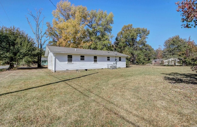 rear view of property with a yard