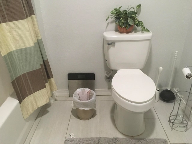 bathroom with toilet and tile patterned flooring