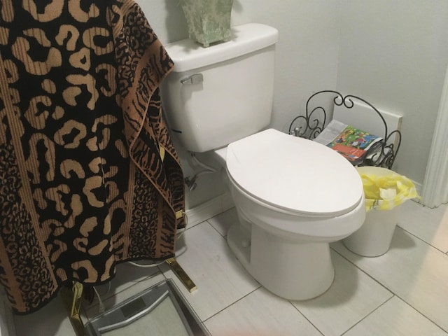 bathroom with toilet and tile patterned flooring