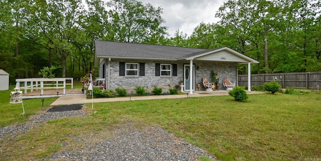 single story home with brick siding, fence, and a front yard