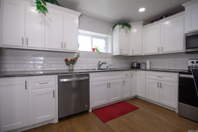 kitchen with white cabinets, stainless steel appliances, recessed lighting, and a sink