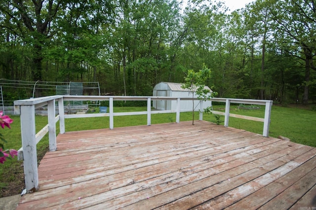 deck featuring a yard, an outdoor structure, and a shed