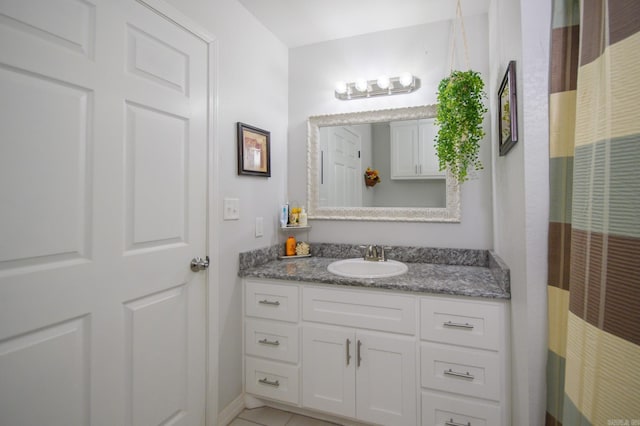 full bath featuring vanity, tile patterned flooring, and a heating unit