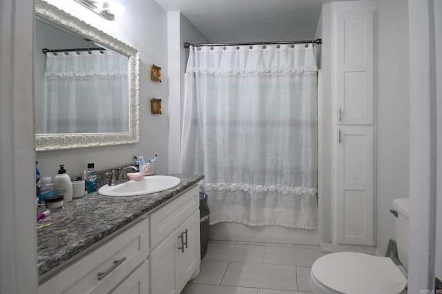 full bath with tile patterned floors, vanity, toilet, and shower / bath combination with curtain
