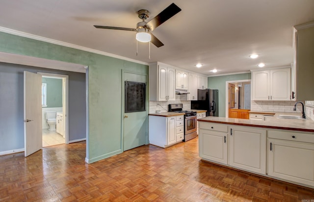 kitchen with light parquet flooring, sink, stainless steel gas range oven, white cabinets, and black fridge with ice dispenser