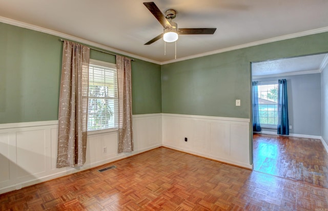 unfurnished room with parquet flooring, crown molding, plenty of natural light, and ceiling fan