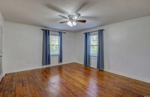 unfurnished room featuring a wealth of natural light, crown molding, hardwood / wood-style flooring, and ceiling fan