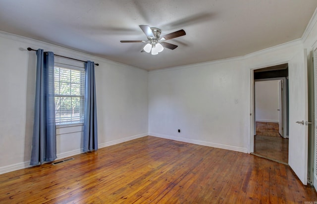 empty room with crown molding, hardwood / wood-style floors, and ceiling fan