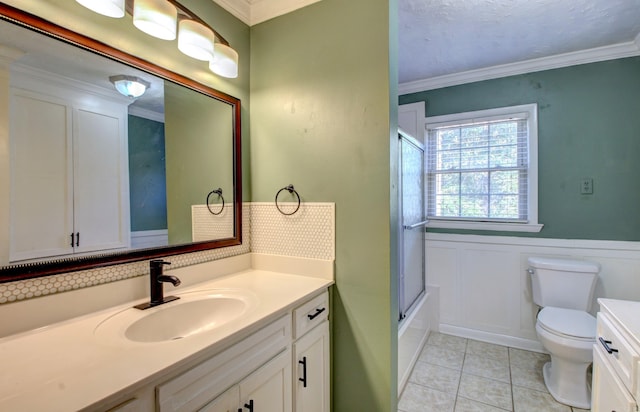 bathroom featuring vanity, toilet, tile patterned floors, and ornamental molding