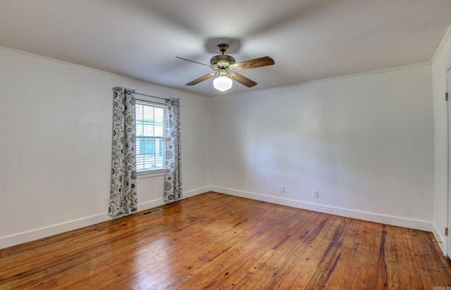 spare room with crown molding, hardwood / wood-style flooring, and ceiling fan